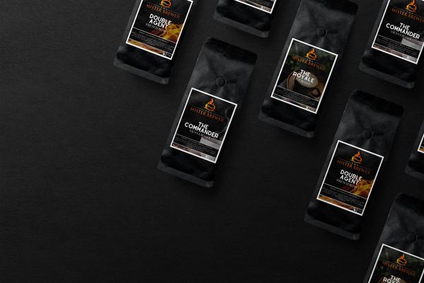 An aerial photo over a dark background showing an angled grid of all the different delicious and smooth coffee roasts available. 