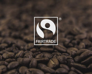 Certified Fairtrade logo overlaid on coffee beans
